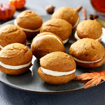 Pumpkin protein whoopie pies stacked on a plate