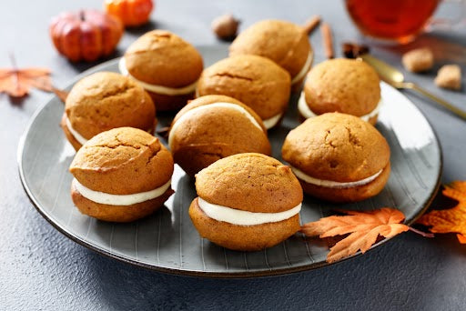 Pumpkin protein whoopie pies stacked on a plate