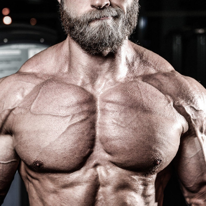 IFBB Pro bodybuilder benching to illustrate the role of genetics