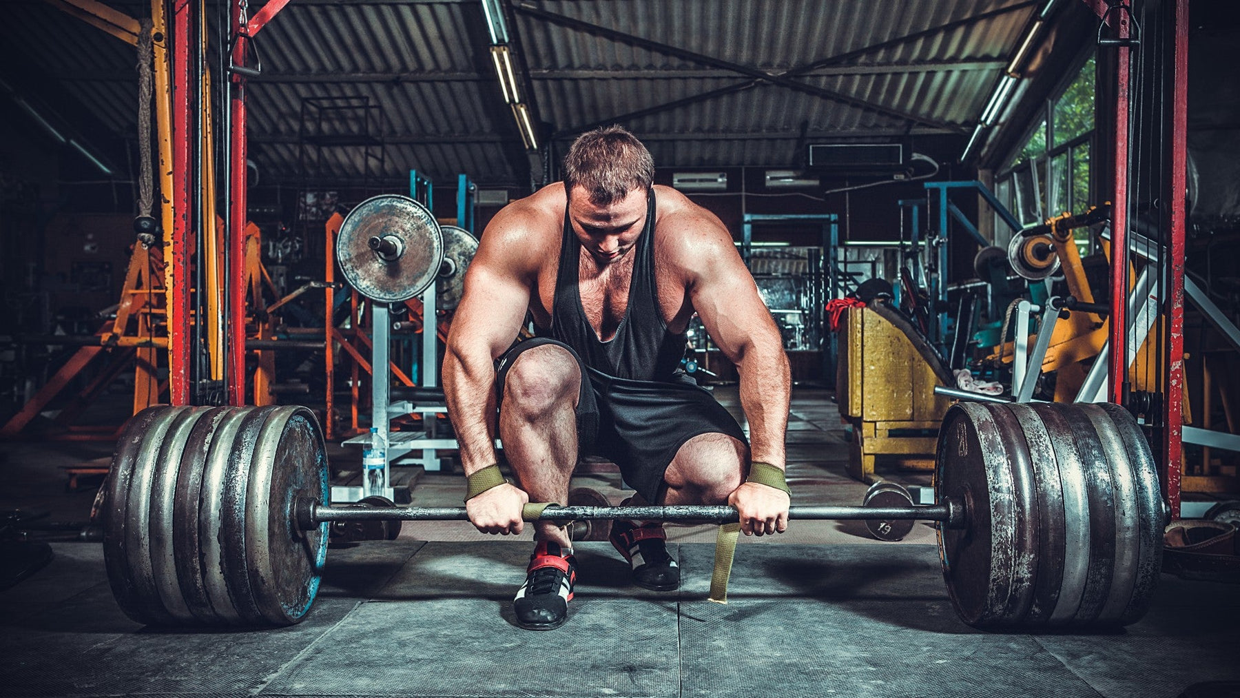Athlete deadlifting using Versa Gripps lifting straps