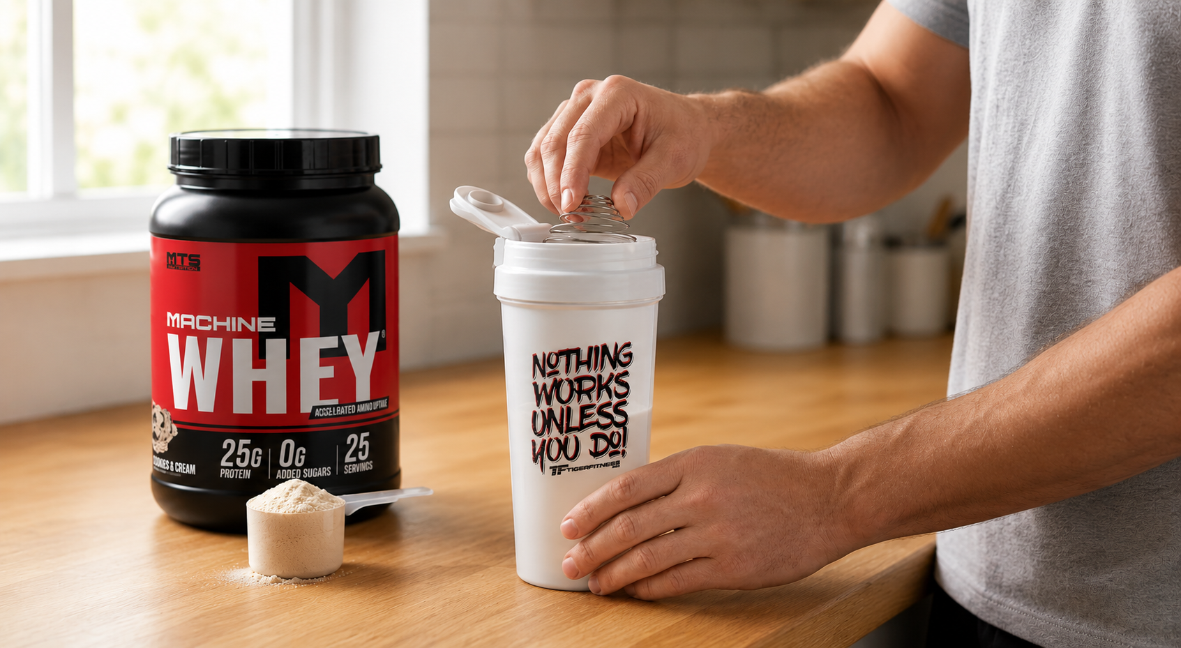 MTS Nutrition Machine Whey protein powder with a Tiger Fitness shaker as an athlete prepares a protein shake on a kitchen countertop.