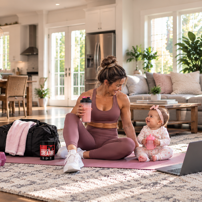 Postpartum athlete at home with her baby, MTS Creapure Creatine, and a protein shaker after a workout.