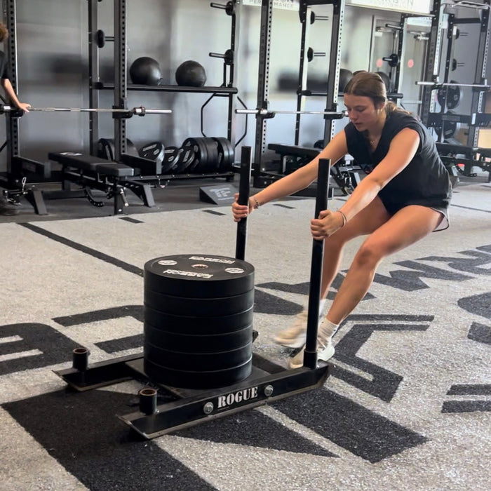 Athlete performing sled push and pull training