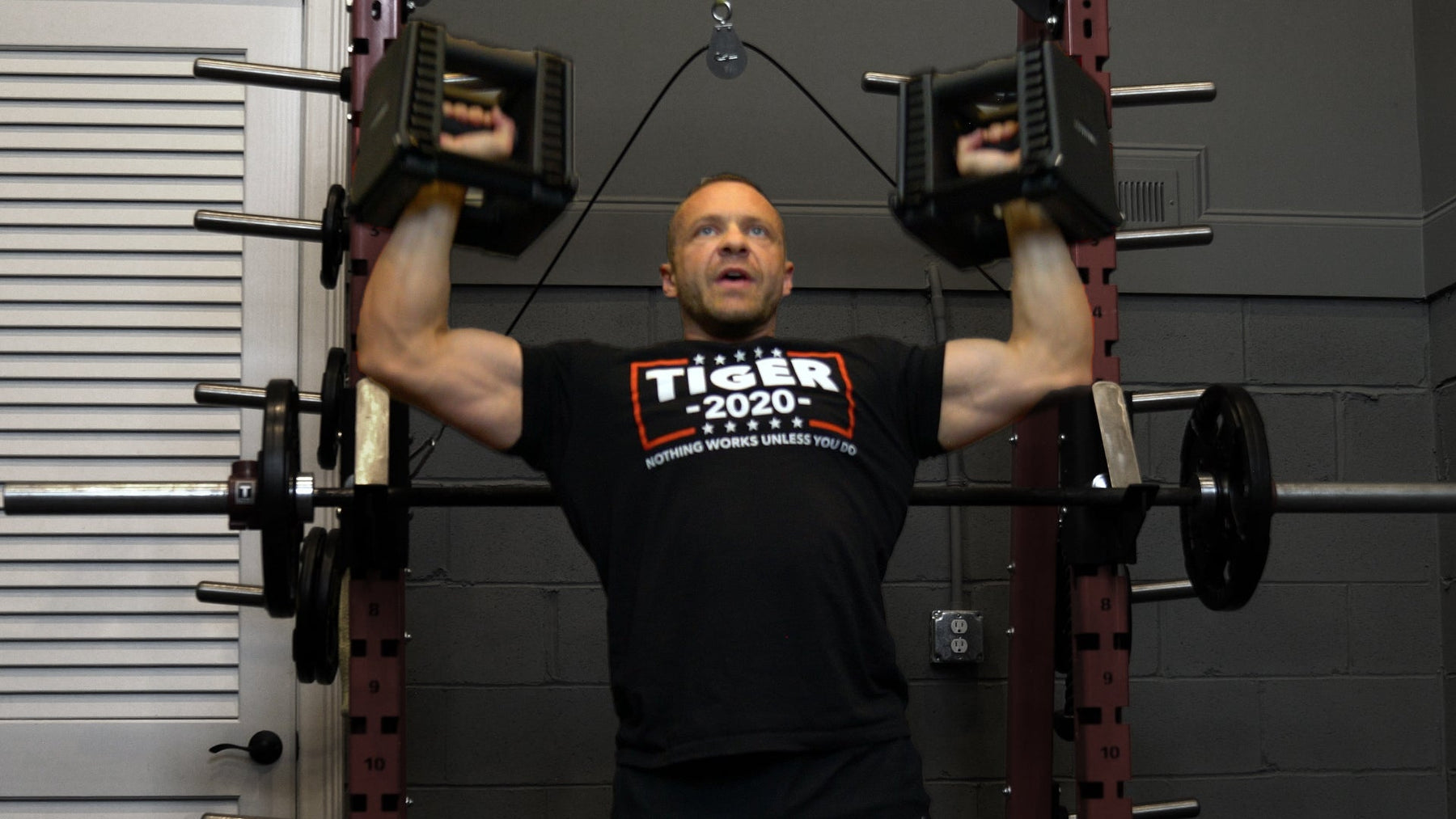 Athlete performing shoulder press variations for bigger shoulders