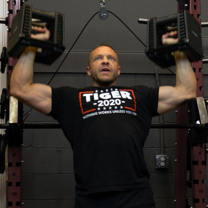 Athlete performing shoulder press variations for bigger shoulders