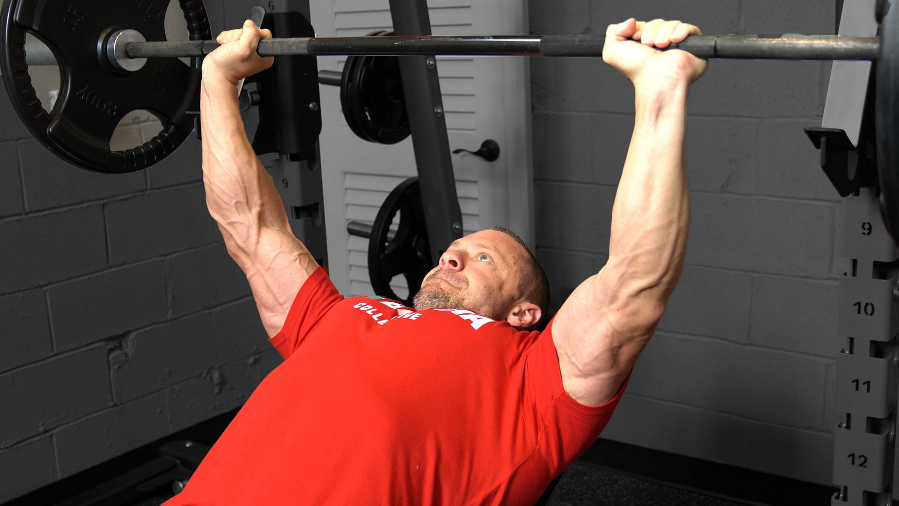 Athlete performing a barbell bench press for chest development