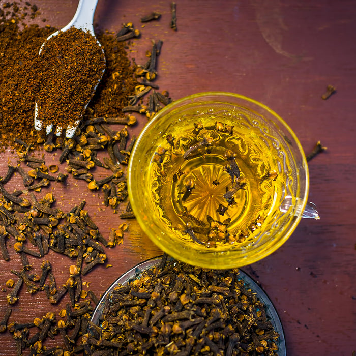 Glass of clove water on a table