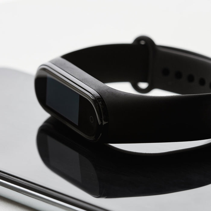 Black fitness tracker watch on a wrist