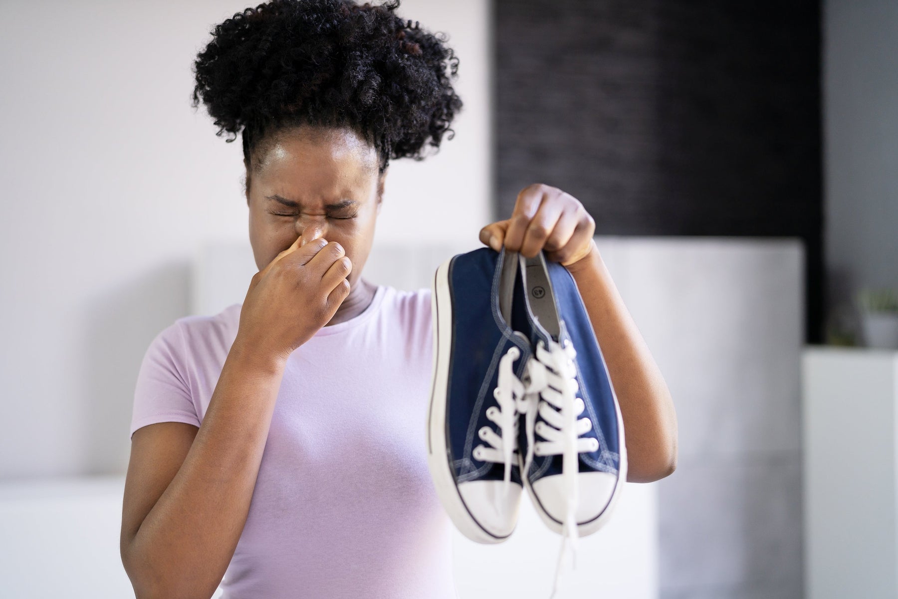 Woman holding gym clothes to prevent odor buildup