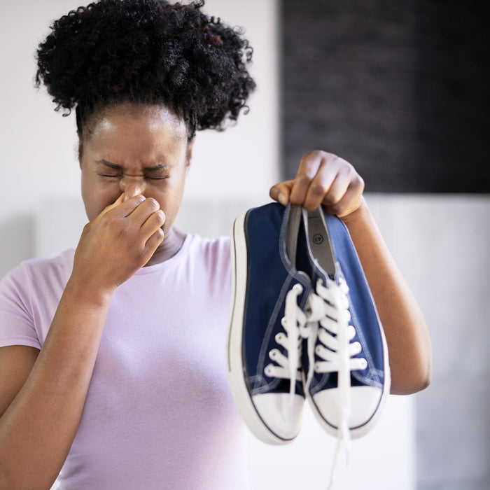 Woman holding gym clothes to prevent odor buildup