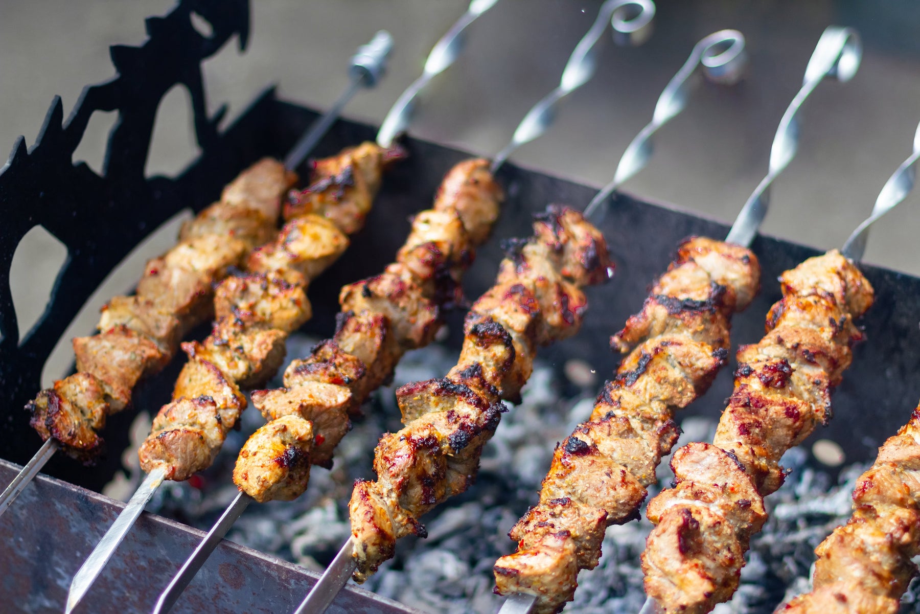 Juicy meat grilling on a barbecue for summertime cooking