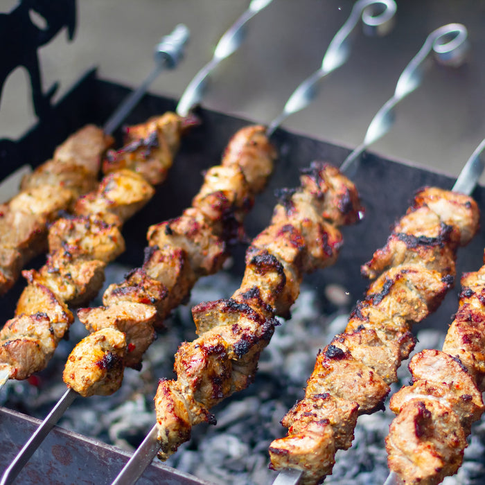 Juicy meat grilling on a barbecue for summertime cooking