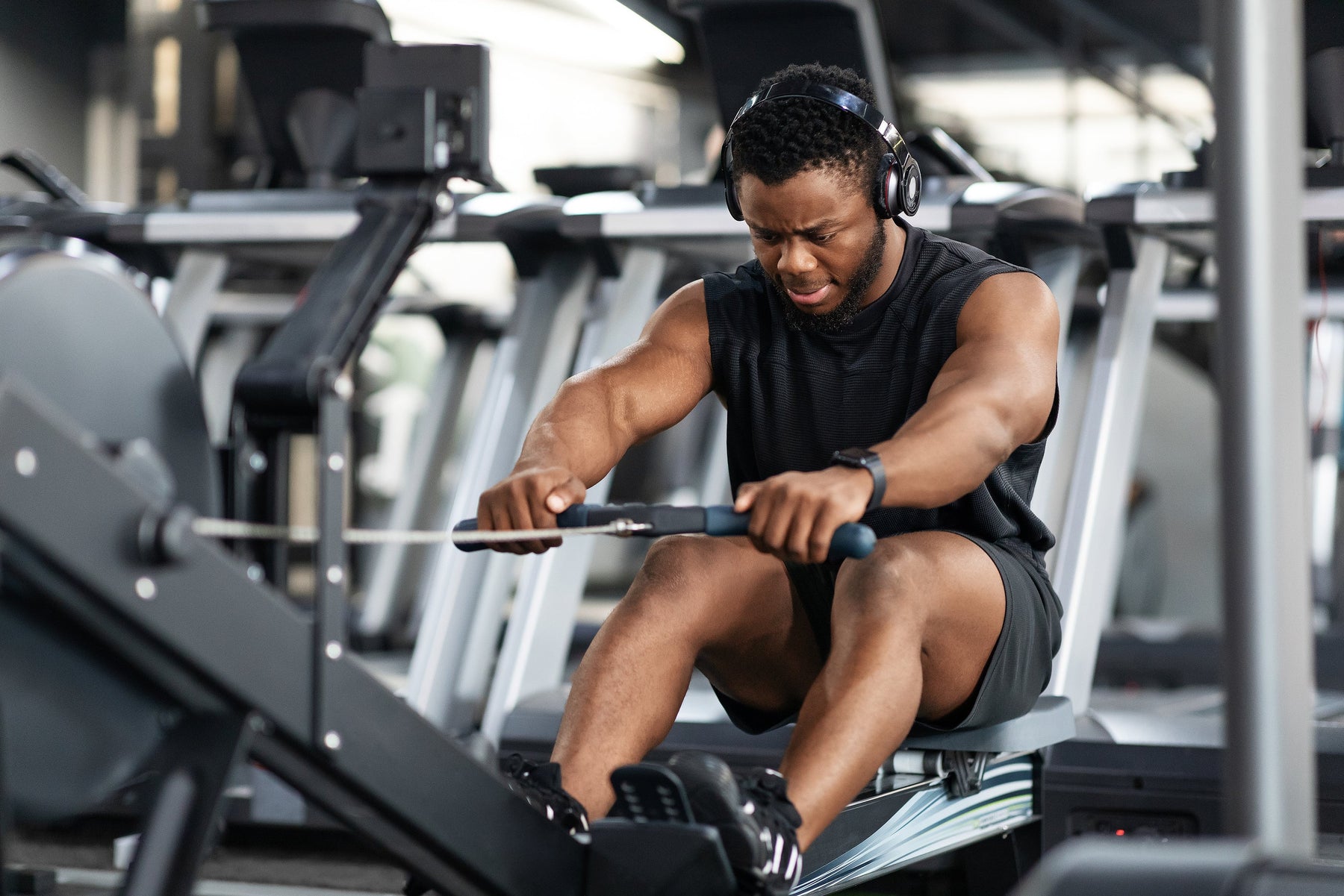 Athlete using a rowing machine for strength and endurance training