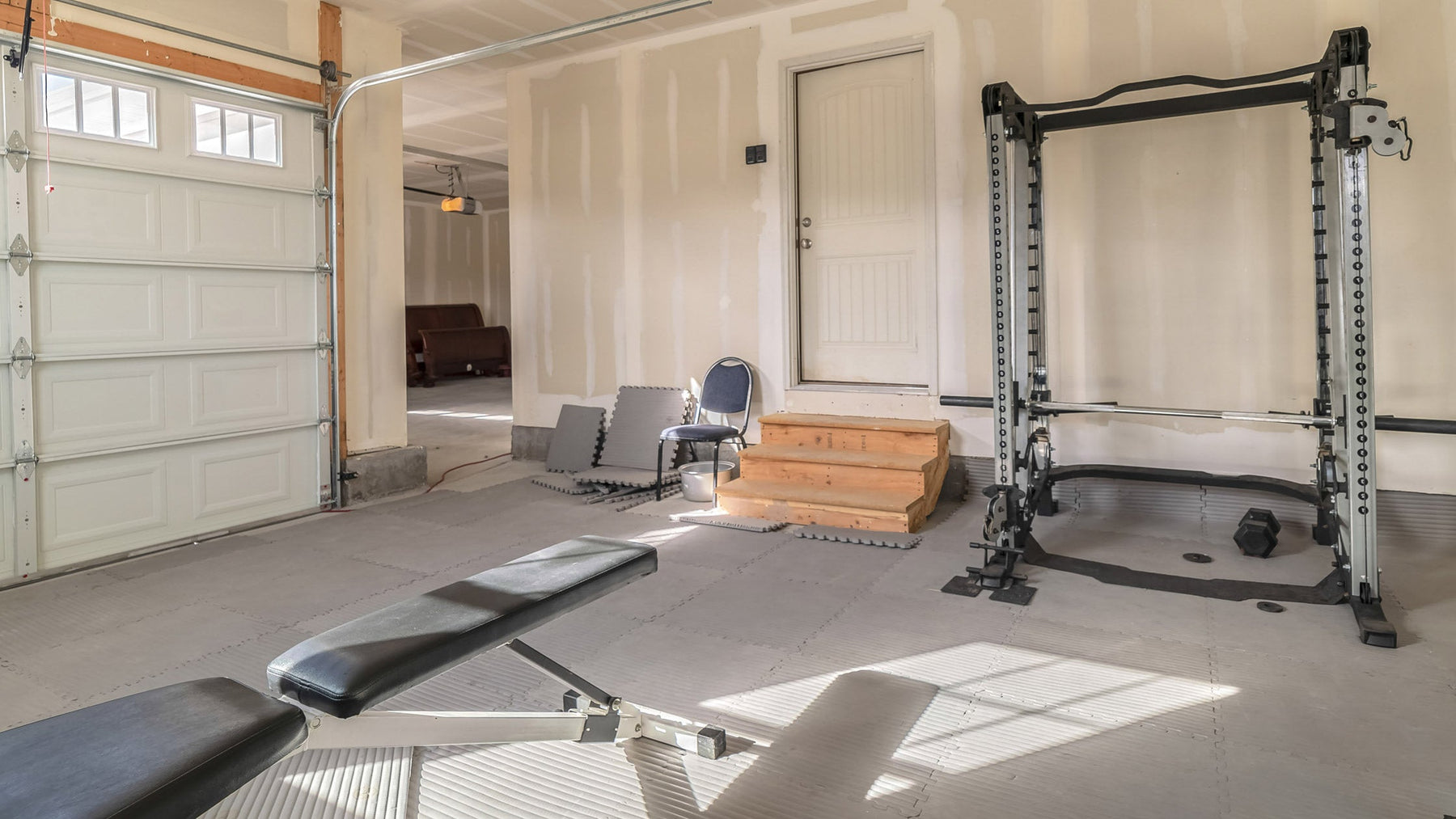 Home gym setup with a variety of exercise equipment