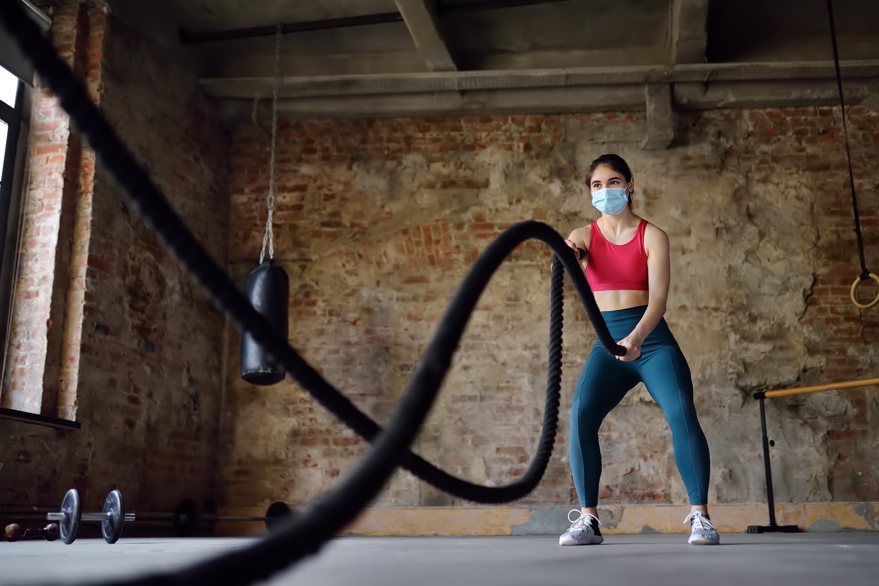Woman wearing a face mask while exercising post pandemic