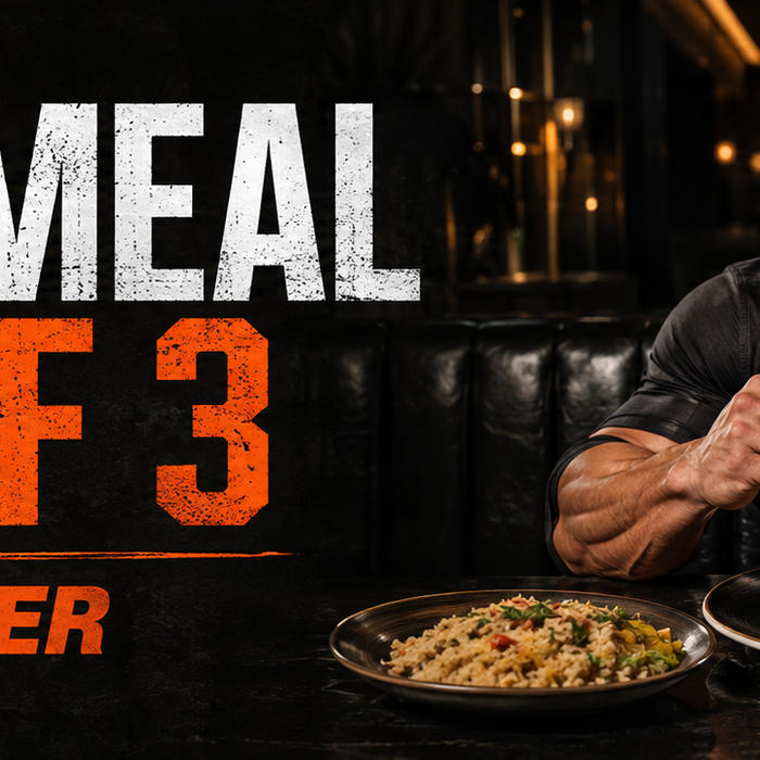 Muscular man enjoying a balanced restaurant meal with text Cheat Meal Rule of 3 – Feast Smarter
