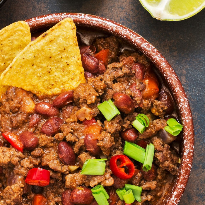 Bowl of shredded chicken chili made in a crockpot