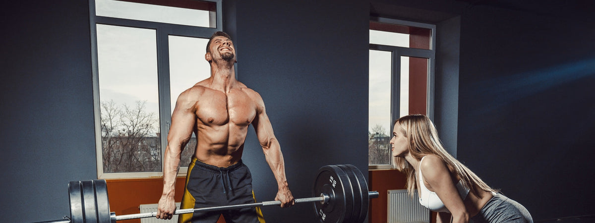 Man performing a heavy barbell deadlift for a six week back and deadlift workout program
