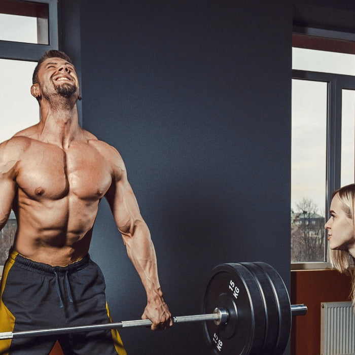 Man performing a heavy barbell deadlift for a six week back and deadlift workout program