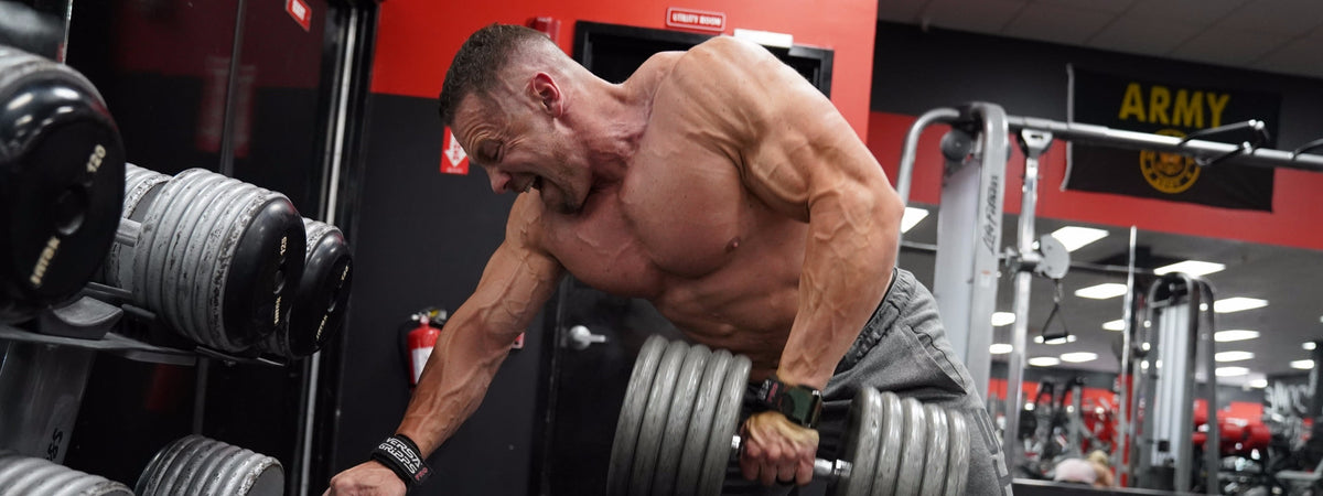 Marc Lobliner performing a heavy dumbbell row during a 5 day workout spli