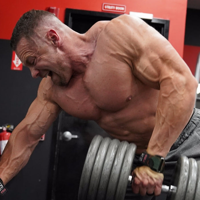 Marc Lobliner performing a heavy dumbbell row during a 5 day workout spli