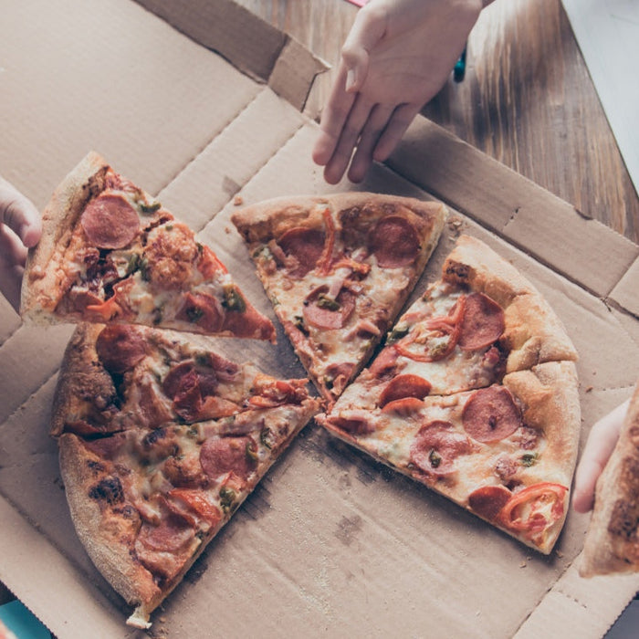 Slice of pizza representing a cheat meal in a flexible diet