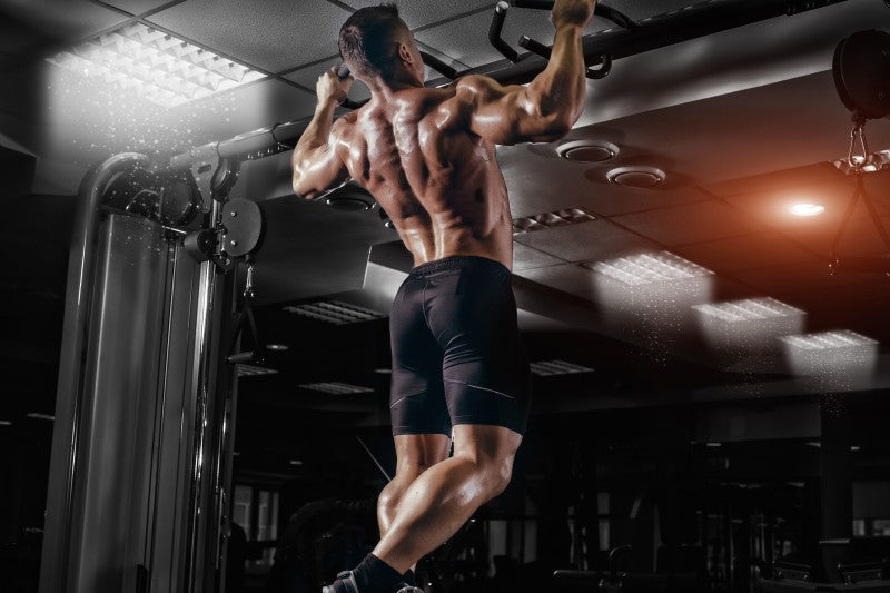Athlete performing pull-ups as part of an EMOM workout