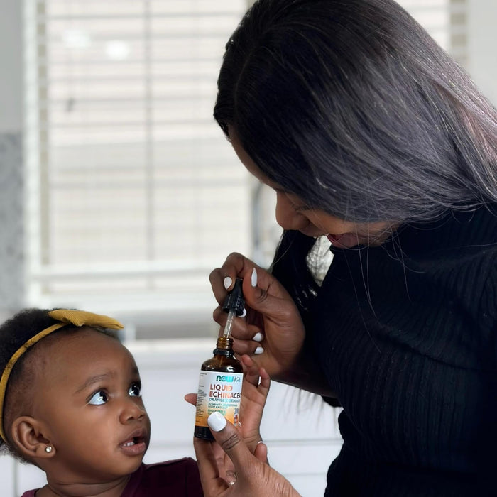 Parent giving child NOW Kids Liquid Echinacea using dropper