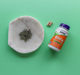 NOW Foods EGCg Green Tea Extract 400 mg bottle with loose green tea leaves and capsules lifestyle image